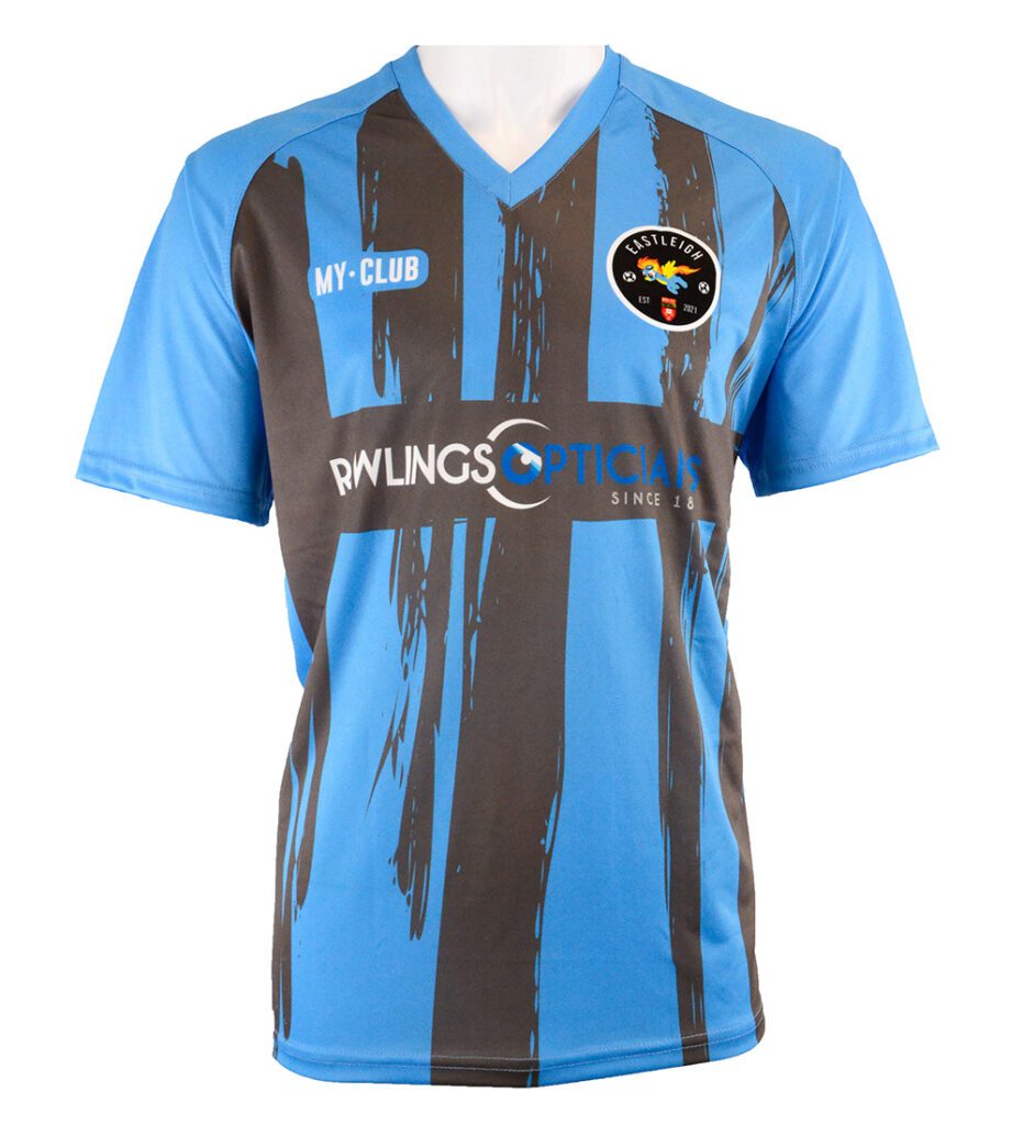 A blue short-sleeve football shirt with black vertical brushstroke stripes, a V-neck collar, and sponsor logos MY CLUB, RAWLINGS OPTICIANS, and a circular team crest on the chest.