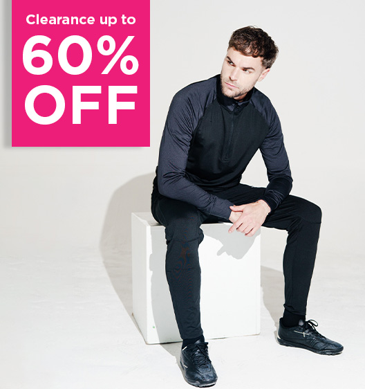 A man in black sportswear sits on a white cube. A bright pink sign beside him reads Clearance up to 60% OFF.