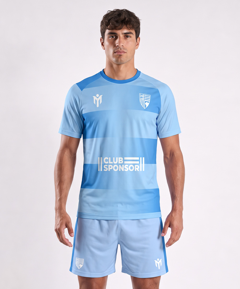 Un homme portant un maillot de football bleu clair à rayures horizontales, sur lequel figurent l'inscription « CLUB SPONSOR » et deux emblèmes blancs, assorti d'un short de football bleu clair similaire à des maillots de tennis personnalisés.